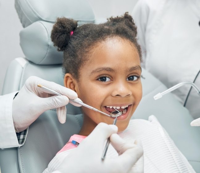 Young girl receiving children's dentistry treatment