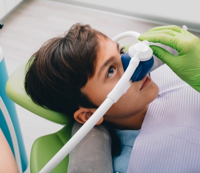 Child receiving nitrous oxide dental sedation treatment