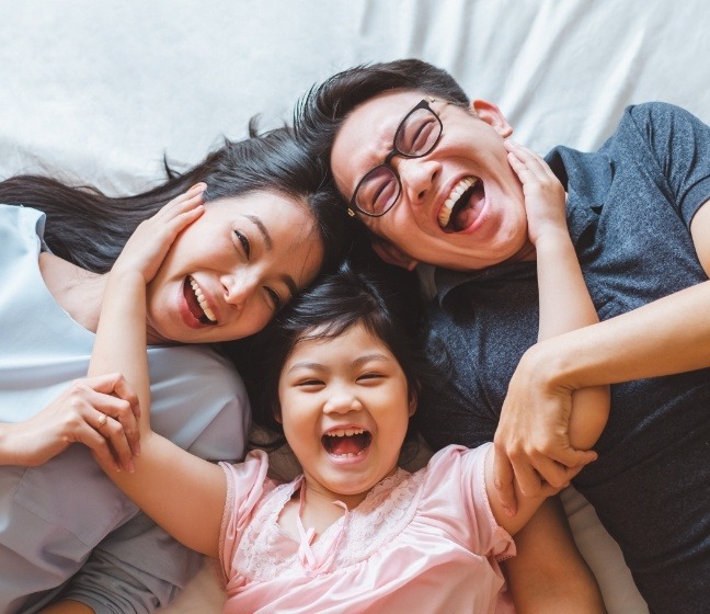 Family laughing together after child received fillings