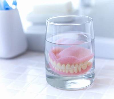 Full dentures in Dallas soaking in solution