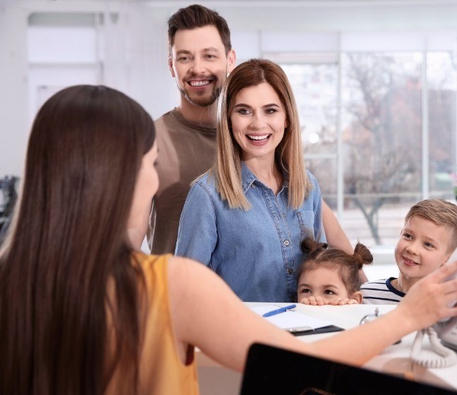 Parents and children discussing the cost of treating dental emergencies