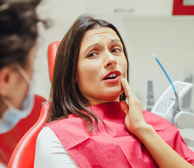 Woman with toothache talking to dentist in Dallas