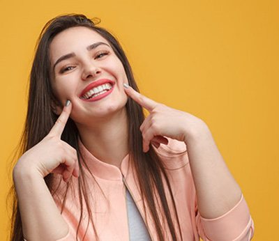 a patient smiling after their tooth extraction in Dallas