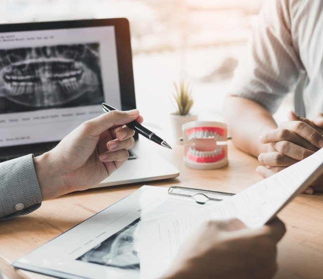 Dentist and patient reviewing dental insurance coverage