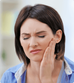 woman holding her mouth in pain