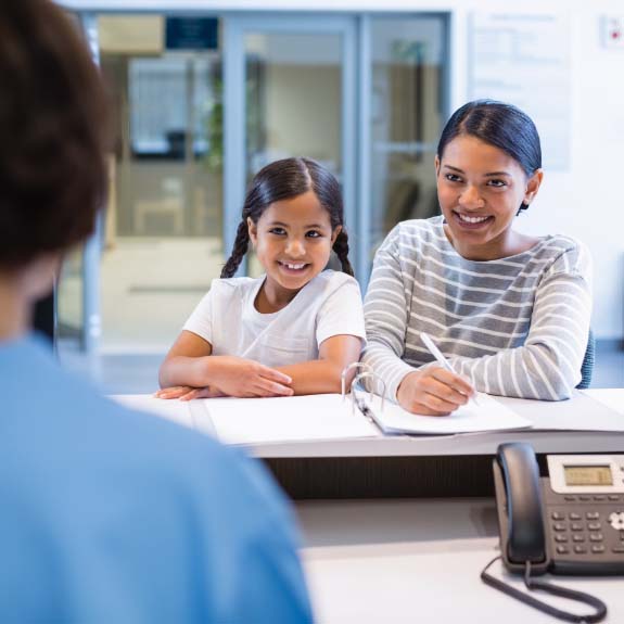 mother and daughter at front desk