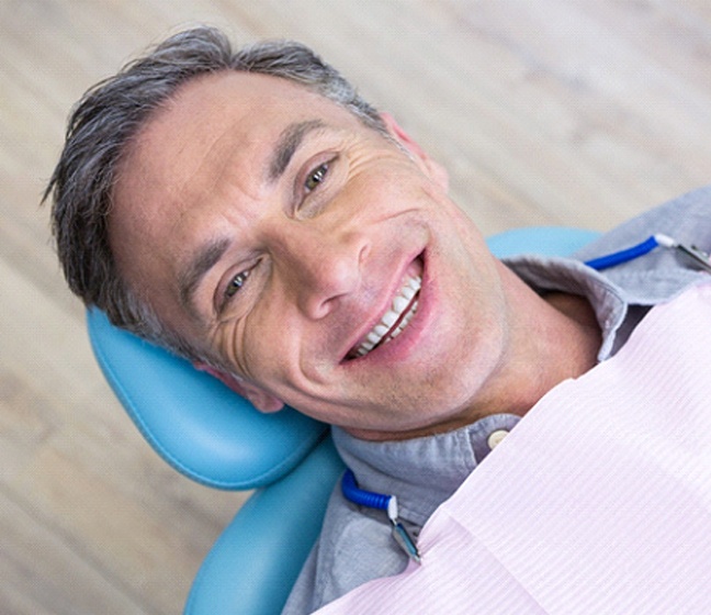 Man smiling in the dentist’s chair in Dallas