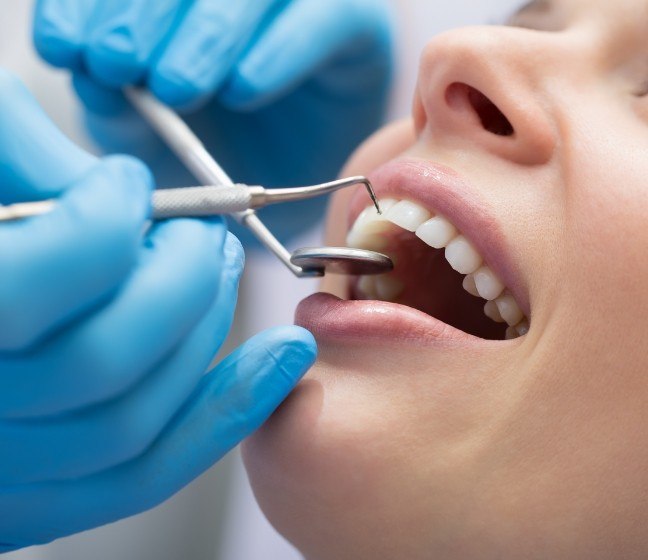 Patient receiving scaling and root planing periodontal disease treatment