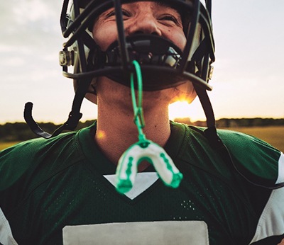 Closeup of mouthguard hanging from football helmet