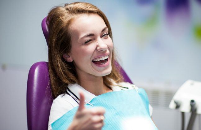 Woman giving thumbs up after preventive dentistry visit