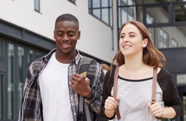 Two young people with healthy smiles after restorative dentistry