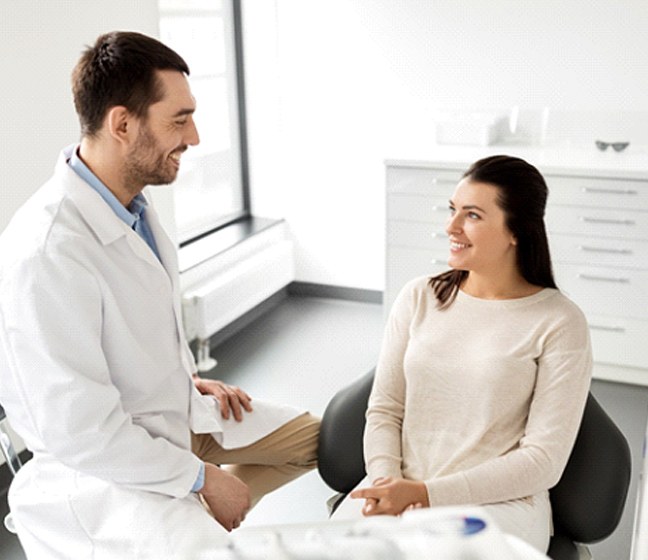 Woman at dentist getting veneers in Dallas