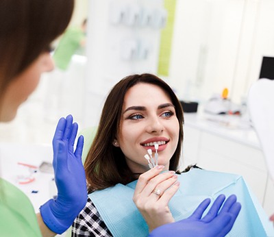 Dentist explaining cost of veneers in Dallas to patient