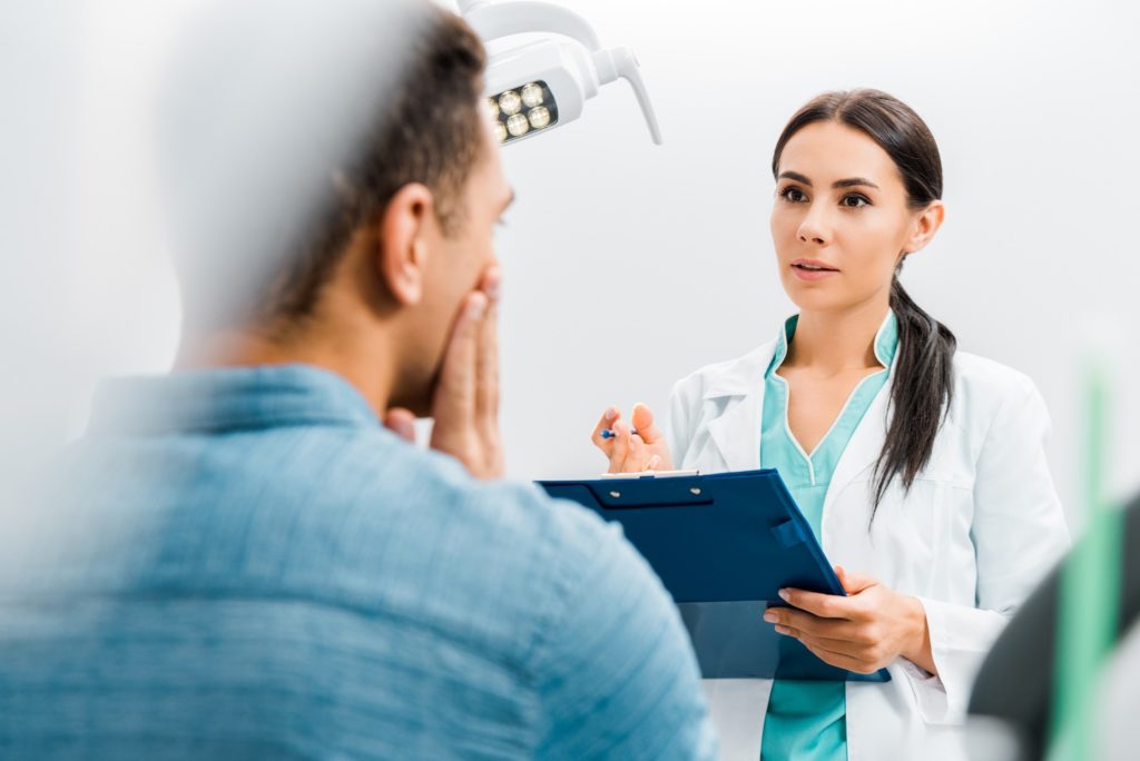 Dentist talking to patient about root canal