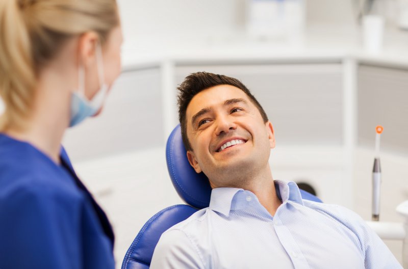 Patient learning the difference between Invisalign and Veneers in Dallas
