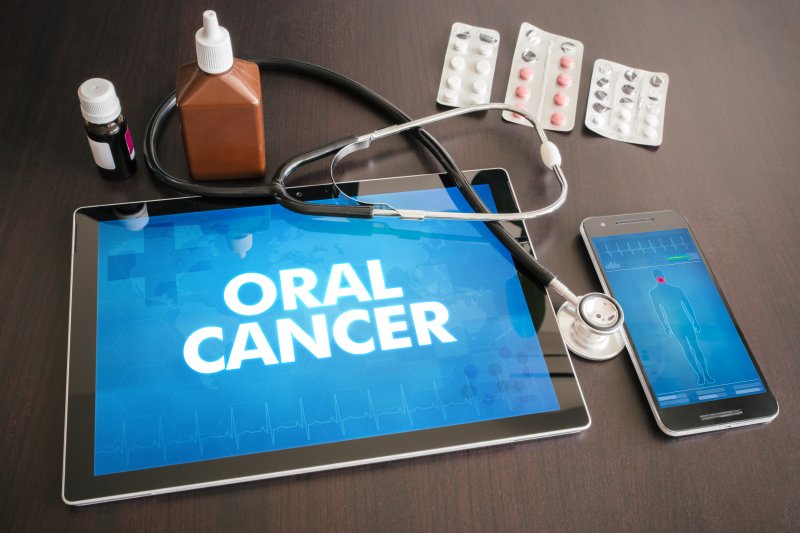 ipad on a table with the word oral cancer on it