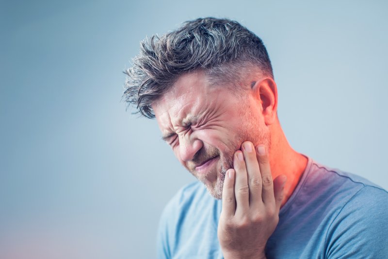 Man has tooth pain.