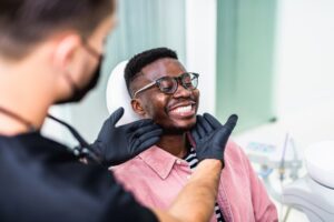 Young man being examined by dentist.
