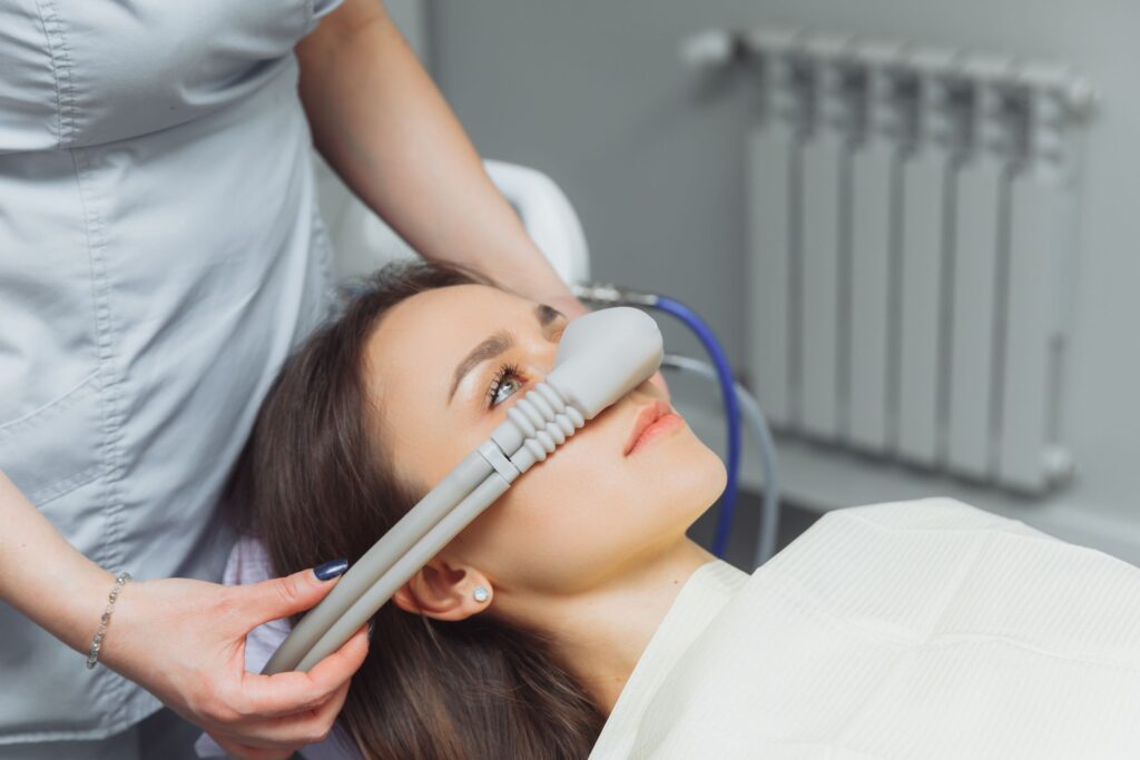 Dentist placing nitrous oxide mask over patient's nose