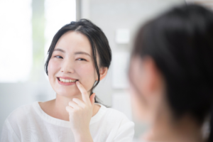 a patient inspecting their smile in a mirror