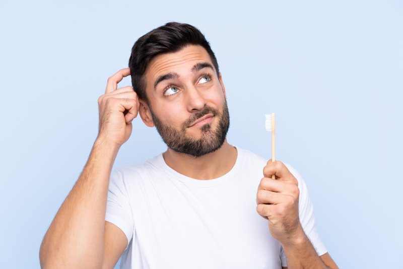 Patient scratching head while thinking about fluoride treatment
